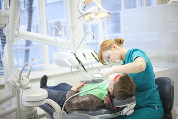 Dental hygienist performing deep cleaning for gum disease treatment